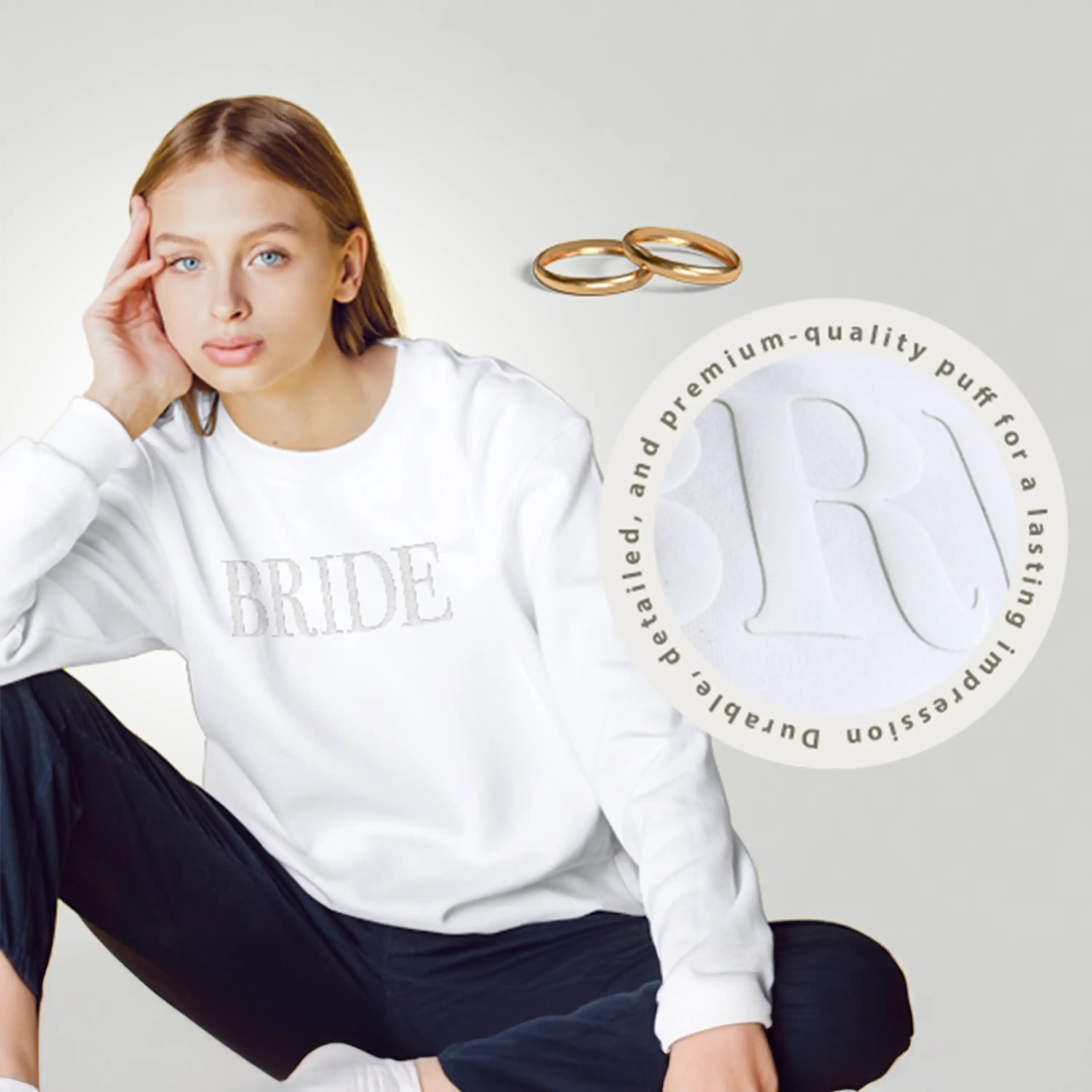Woman wearing a white 'BRIDE' sweatshirt with gold rings and a circular logo on a light gray background.