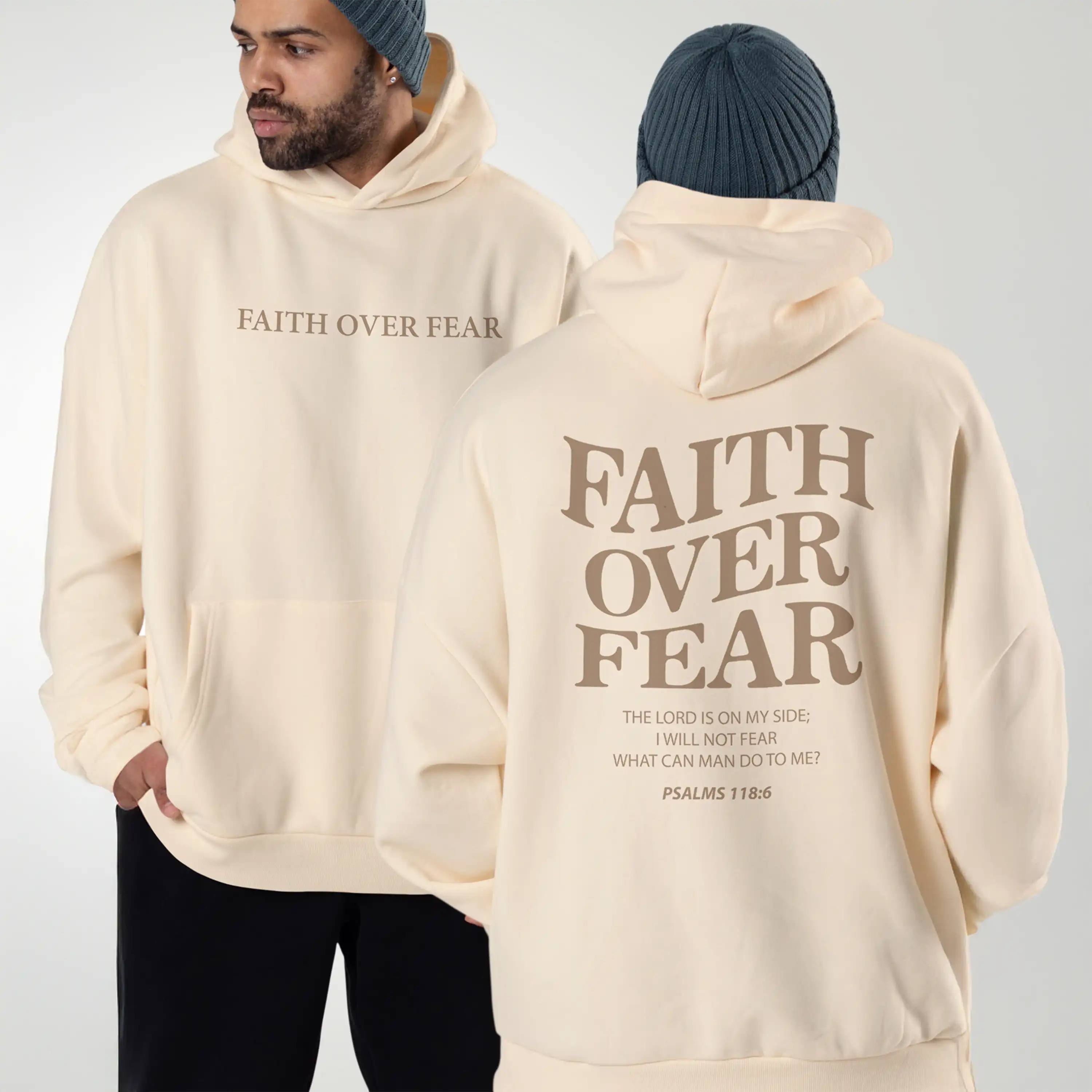 Two people wearing cream hoodies with 'Faith Over Fear' text, one facing forward and one facing backward.